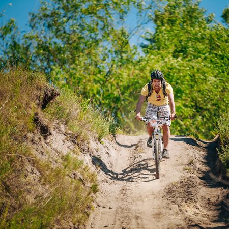 GOMEL, BELARUS - JUNE 7, 2015: Mountain Bike cyclist riding track at sunny day, healthy lifestyle active athlete doing sportのeditorial素材