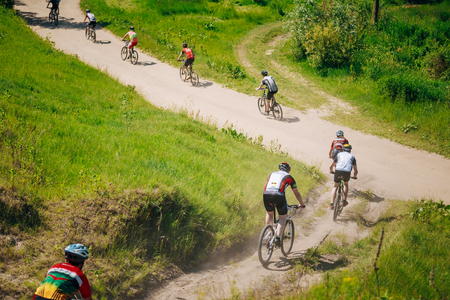 GOMEL, BELARUS - JUNE 7, 2015: Group Of Mountain Bike cyclists riding track at sunny day, healthy lifestyle active athlete doing sportのeditorial素材