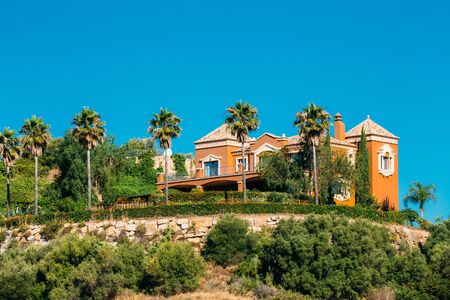 The Village With Red Colors Houses In Andalusia, Spain. Summer Cityscape. Sunny Day With Good Weather and Clear Blue Skyの写真素材