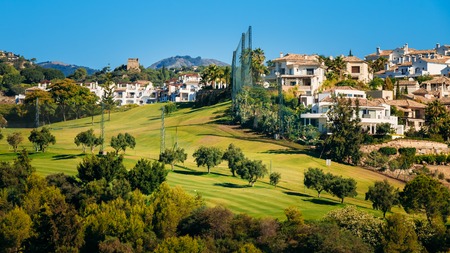 Panorama of Village With Whitewashed Houses In Benahavis, Malaga, Andalusia, Spain. Summer Cityscape. Sunny Day With Good Weather and Clear Blue Skyの写真素材