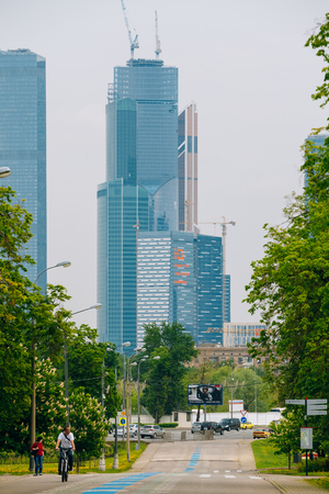 Moscow, Russia - May 24, 2015: People walking in the park of Victory in Moscow. In the background you can see one of the buildings of the business district Moscow City.のeditorial素材