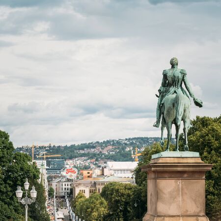 OSLO, NORWAY - JULY 31, 2014: Statue of Norwegian King and main street Karl Johans Gate leading to the Royal Palaceのeditorial素材