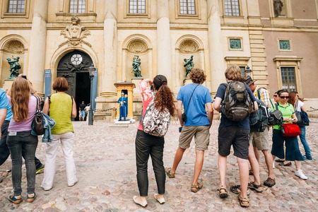 STOCKHOLM, SWEDEN - JULY 30, 2014: Tourists visit and photograph the guard of honor at the Royal palace in Gamla Stan, where king Carl XVI Gustaf has his working office.のeditorial素材