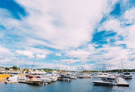 OSLO, NORWAY - JULY 31, 2014: View of Embankment In district Aker Brygge in Oslo, Norway. Summer Evening. Aker Brygge is a popular area for for shopping, dining, and entertainment.のeditorial素材