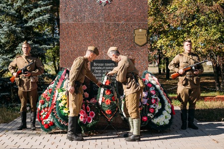 Teryuha, Belarus - October 3, 2015: Unidentified re-enactors dressed as Soviet soldiers laying of wreaths at mass grave of Soviet soldiers who died during battles for liberation of Belarus in WWII.のeditorial素材