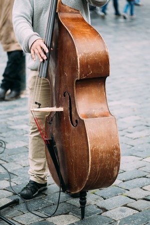 Street Busker performing jazz songs. Close up of contrabassの写真素材