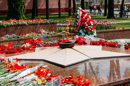 Wreaths and flowers lie on a communal grave of Soviet soldiers who died during the liberation of Gomel and Belarus from German invaders in World War II.の写真素材