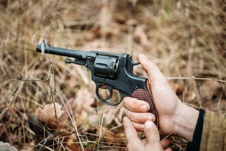 Unidentified re-enactor dressed as Soviet russian soldier holding a gun pistol World War II.の写真素材