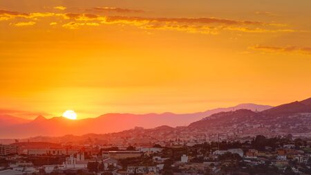 Panorama Beautiful Sunset Sunrise Over Mountain and city.の写真素材