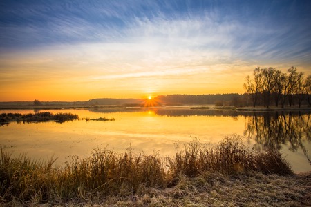 Sunrise over Lake, River and forest horizon in autumn morning. Sunset.の写真素材