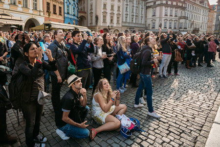 Prague, Czech Republic - October 13, 2014: Group of tourists taking photo of town hall with...