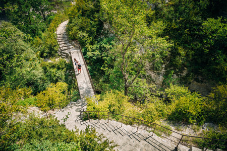 Tourists descend the steps to the mountain river Le Verdon in the Verdon Gorge in south-eastern...
