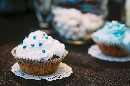 Dessert Sweet Tasty cupcake in Candy Bar On Table. Delicious sweet buffet. Wedding decorationsの写真素材