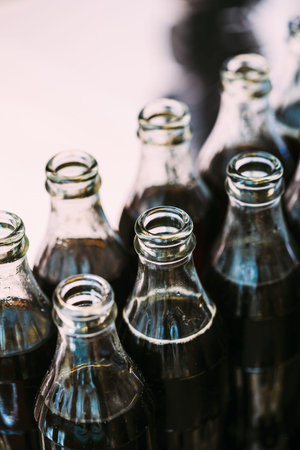 Refreshing Brown Soda in bottles in Candy Bar On Table. Delicious sweet buffet.の写真素材