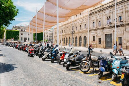 Seville, Spain - June 24, 2015: Motorbikes, motorcycles, scooters parked in city.のeditorial素材