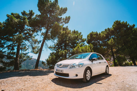 Mijas, Spain - June 19, 2015: White color Toyota Auris car on Spain nature landscape. The Toyota Auris is a compact hatchback derived from the Toyota Corollaのeditorial素材