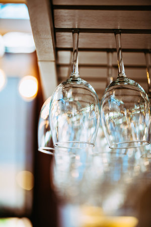 Glasses hanging over bar rack. Glasses for wine above a bar rack