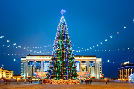 Christmas tree, illuminations and decorations in front of building of the Palace of Republic in Oktyabrskaya Square - famous place in central Minsk, Belarus.の写真素材