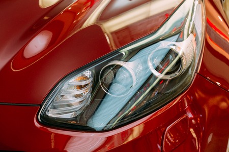 Vilnius, Lithuania - July 08, 2016: Close The Left Headlight Of New Red Kia Sportage Car, The Compact SUV In The Hall Of Acropolis Shopping Center.のeditorial素材