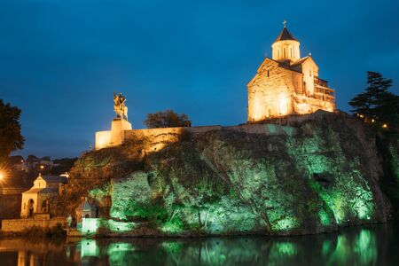 Night Evening Illuminated View Of The Metekhi Church And The Equestrian Statue Of King Vakhtang Gorgasali On The Metekhi Cliff In Old Historic District Of Tbilisi Georgia. Blue Hour. Blue Evening Sky.の写真素材