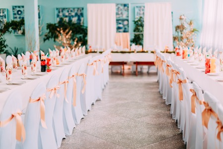 Decorative White Mantles And Colored Ribbons On Chairs At Festive Tableの写真素材