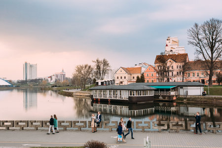 Minsk, Belarus. Young people walking on promenade in old part of Minsk - district Nemiga near Trojeckaje Pradmiescie. Svisloch Riverのeditorial素材