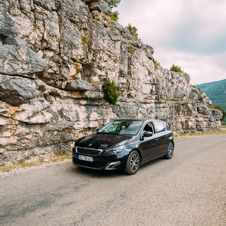 Black colour Peugeot 308 car on background of French mountain naのeditorial素材