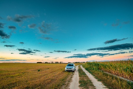 Volkswagen Polo Car Sedan Parking Near Country Road In Summer Fieldのeditorial素材
