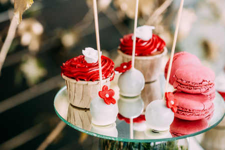 Dessert Sweet Tasty Cupcakes And Macarons In Candy Bar On Table.の写真素材