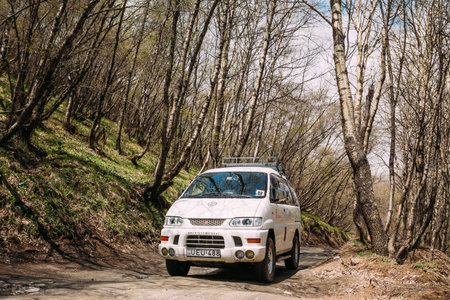 Stepantsminda Gergeti, Georgia - May 23, 2016: Mitsubishi Delica Space Gear on country road in spring mountains landscape. Delica is a range of trucks and multi-purpose vehicles produced by Mitsubishi Motors.のeditorial素材