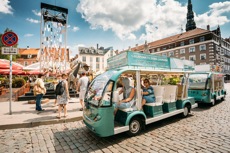 Riga, Latvia. Electric Car With Tourists People For Exploring Citys Attractionsのeditorial素材
