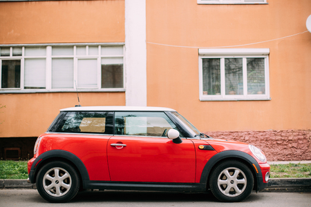 Red Color Car Mini Cooper Parked On Street Near Residential Houseのeditorial素材