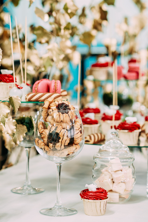 Dessert Sweet Tasty Cupcakes, Cookies In Candy Bar On Table.の写真素材