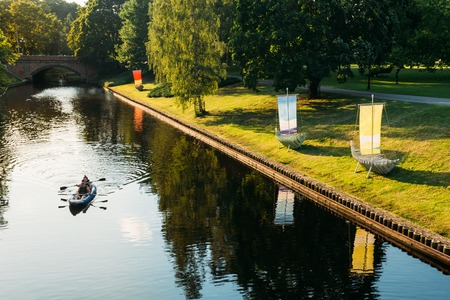 Riga, Latvia. People In A Boat Sailing Along The City River Canalのeditorial素材