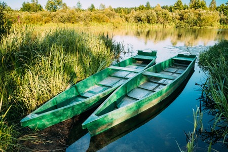 Lake Or River And Two Old Wooden Blue Rowing Fishing Boats At Beautiful Summer Sunny Day Or Evening.の写真素材