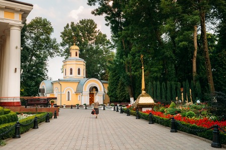 Gomel, Belarus. Woman Visiting Church Near Peter And Paul Cathedral In City Park At Summer Evening In Gomel, Belarus.の写真素材