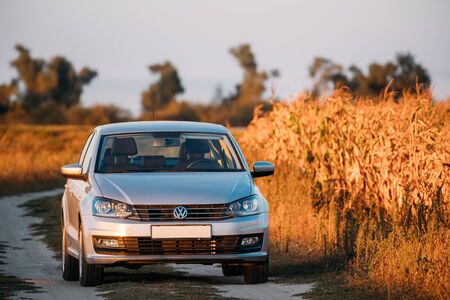 Gomel, Belarus - September 14, 2016: Volkswagen Polo Vento Car Sedan Parking Near Country Road In Autumn Field In Sunny Evening.のeditorial素材