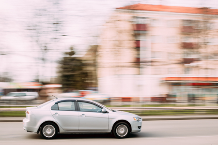 Gray Color Sedan Car Mitsubishi Lancer In Fast Motion On Street.のeditorial素材