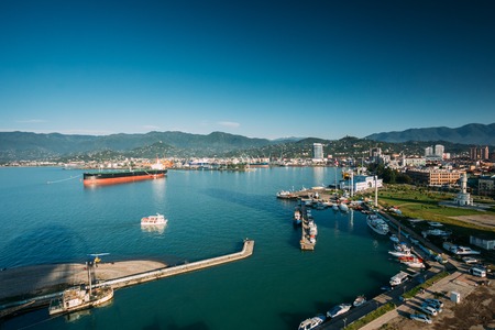 Batumi, Adjara, Georgia - May 25, 2016: Aerial View Of Port Dock On Sunny Evening At Sunset Or Sunrise Time. Sunny Landscape Of Local Embankment With Small Pleasure Boat On Large Tanker On Background.のeditorial素材