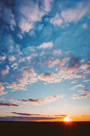 Sunset Sunrise Over Field Or Meadow. Bright Dramatic Sky And Darkの写真素材