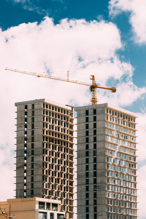Construction Crane Is Involved In The Construction Of A New Multi-storey Residentials Housesの写真素材
