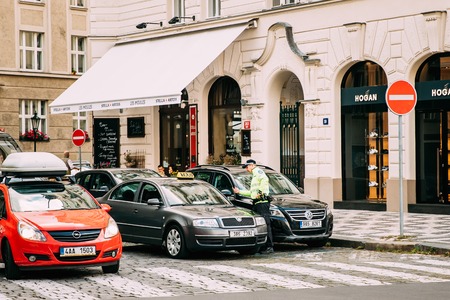 Prague, Czech Republic. Policeman Stop Skoda Taxi Car On Street.のeditorial素材