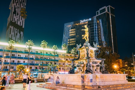 Batumi, Adjara, Georgia - September 8, 2017: Neptune Fountain In Park On Rustaveli Ave. Famous Landmark Against Of Radisson Blu Hotel Background In Night Illuminations Lightsのeditorial素材