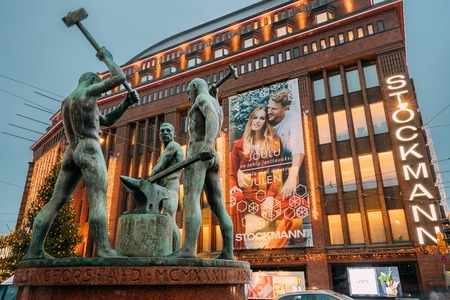 Helsinki, Finland - December 8, 2016: Night View Of Famous Sculpture Group Three Smiths Statue Near Stockmann Shop In Evening Or Night Illuminationのeditorial素材