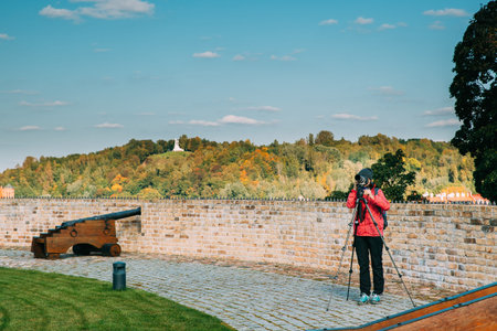 Vilnius, Lithuania. Young Woman Girl Tourist Taking Photos On Camera