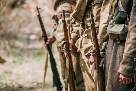 Close Up Of Re-enactors Dressed As Soviet Infantry Soldiers Of World War II Holds Rifles Weapons In Hands.の写真素材