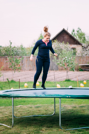 Young Caucasian Beautiful Plus Size Woman Girl Jumping On Trampolineの写真素材