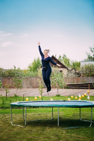 Young Caucasian Beautiful Plus Size Woman Girl Jumping On Trampoの写真素材