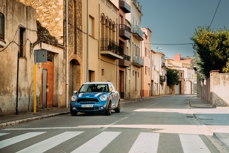 Blue Mini Cooper Countryman Driving  In Old Narrow Spanish Streeのeditorial素材