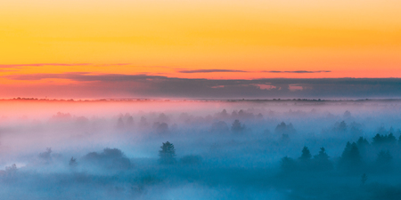 Sunrise Over Misty Landscape. Scenic View Of Foggy Morning Sky Aの写真素材